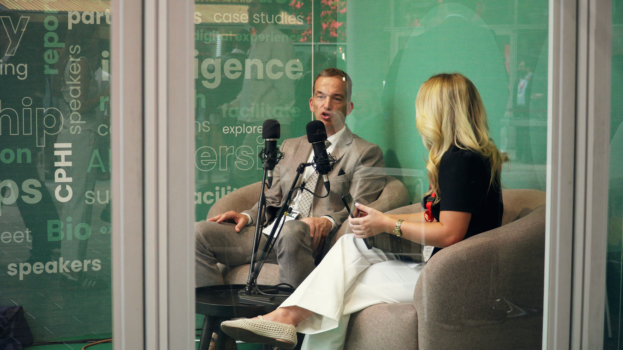 An interview in the ARTO studio at CPHI Milan, seen through the glass